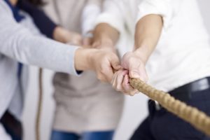 39597443 – group of businesspeople playing tug-of-war, focus on hands. 39597443 - group of businesspeople playing tug-of-war, focus on hands.